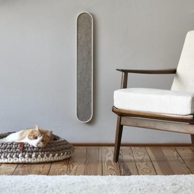 A cat sitting on top of a wooden floor in a bed