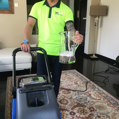 A man deep cleaning a room