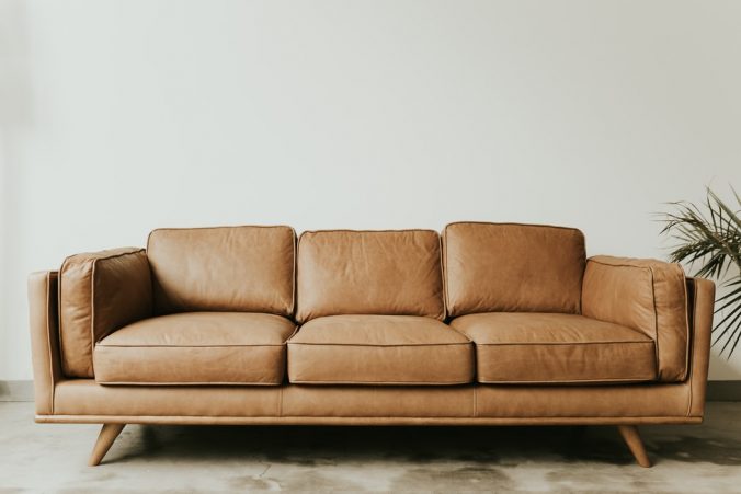 A brown leather couch in a living room