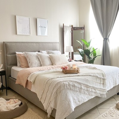 A bedroom with a large bed by Vianne Khoury
