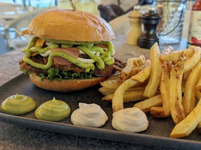A sandwich with lettuce and fries on a table